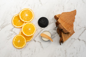 Orange marble wood natural deodorant cream based bamboo applicator natura nordic wood piece chunk flat lay